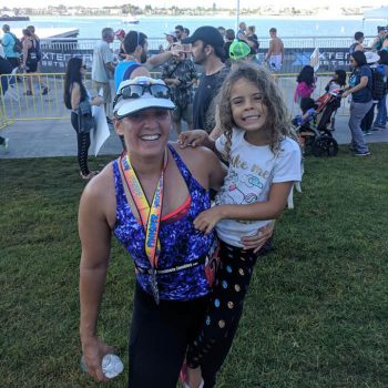 Amanda celebrates at the finish line of the Rock the Bay Triathlon benefiting the Challenged Athletes Foundation